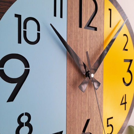 Colorful wall clock with blue, yellow, and brown sections.