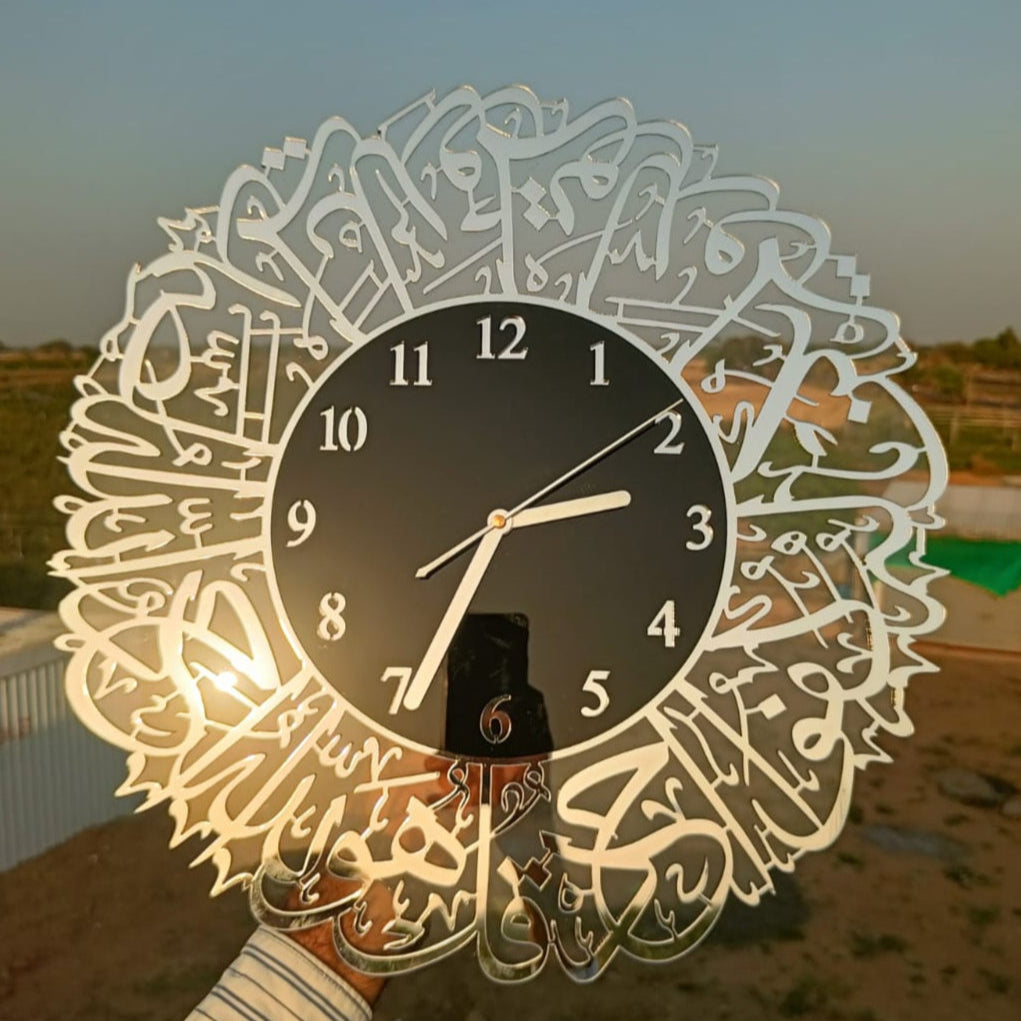 Decorative wall clock with Arabic calligraphy held by a person against a scenic background.