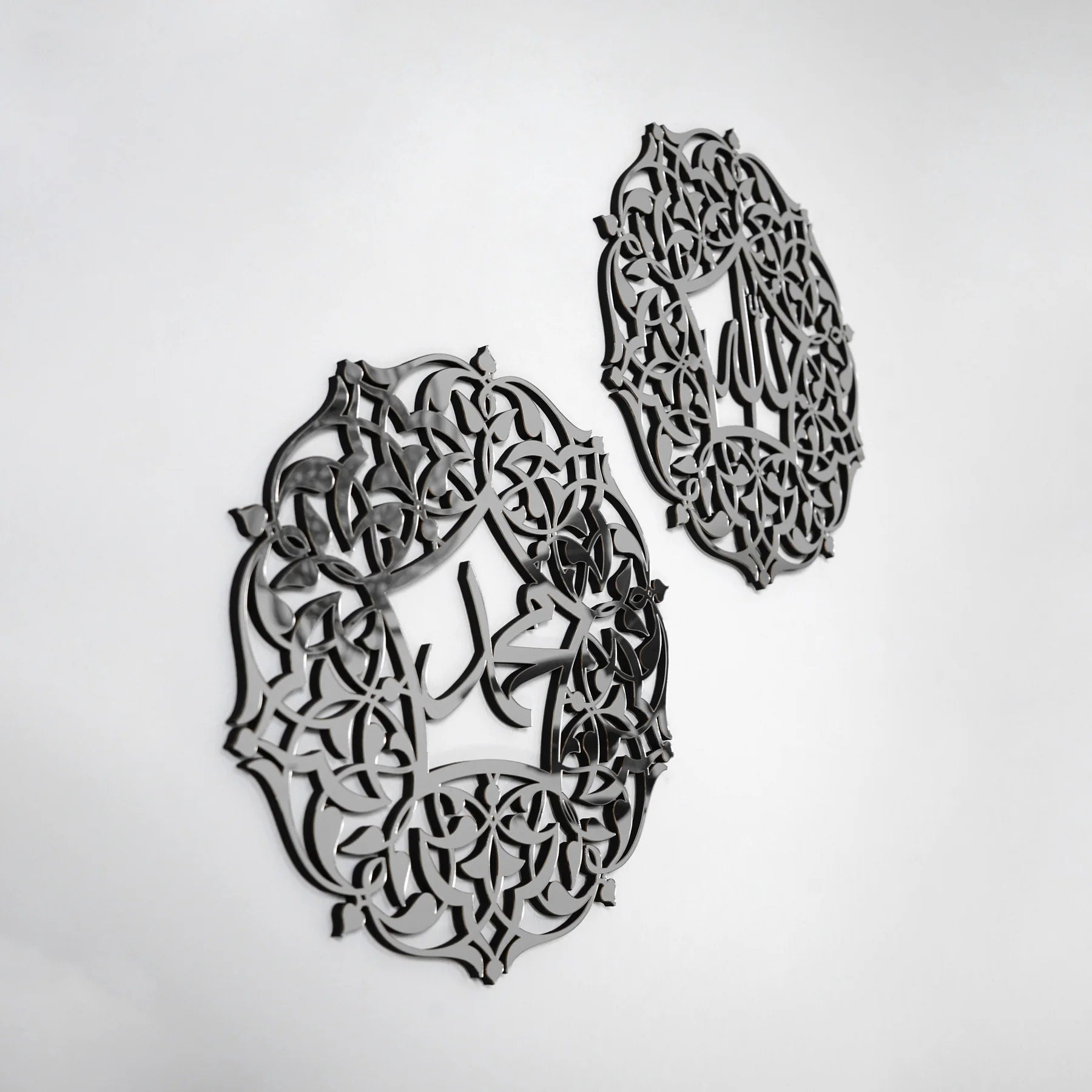 Decorative metal wall art pieces with intricate patterns on a white background