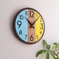 Round wall clock with a wooden frame and colored sections on a light background