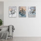 Three abstract art pieces with Arabic calligraphy on a wall above a sofa.