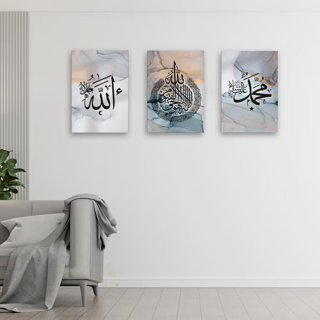 Three abstract art pieces with Arabic calligraphy on a wall above a sofa.