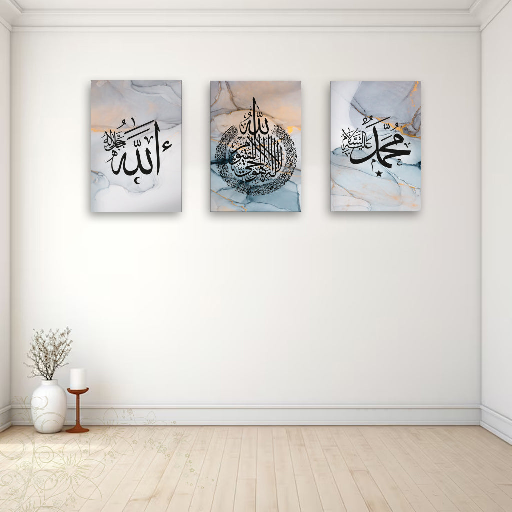 Three abstract art pieces with calligraphic designs on a white wall.