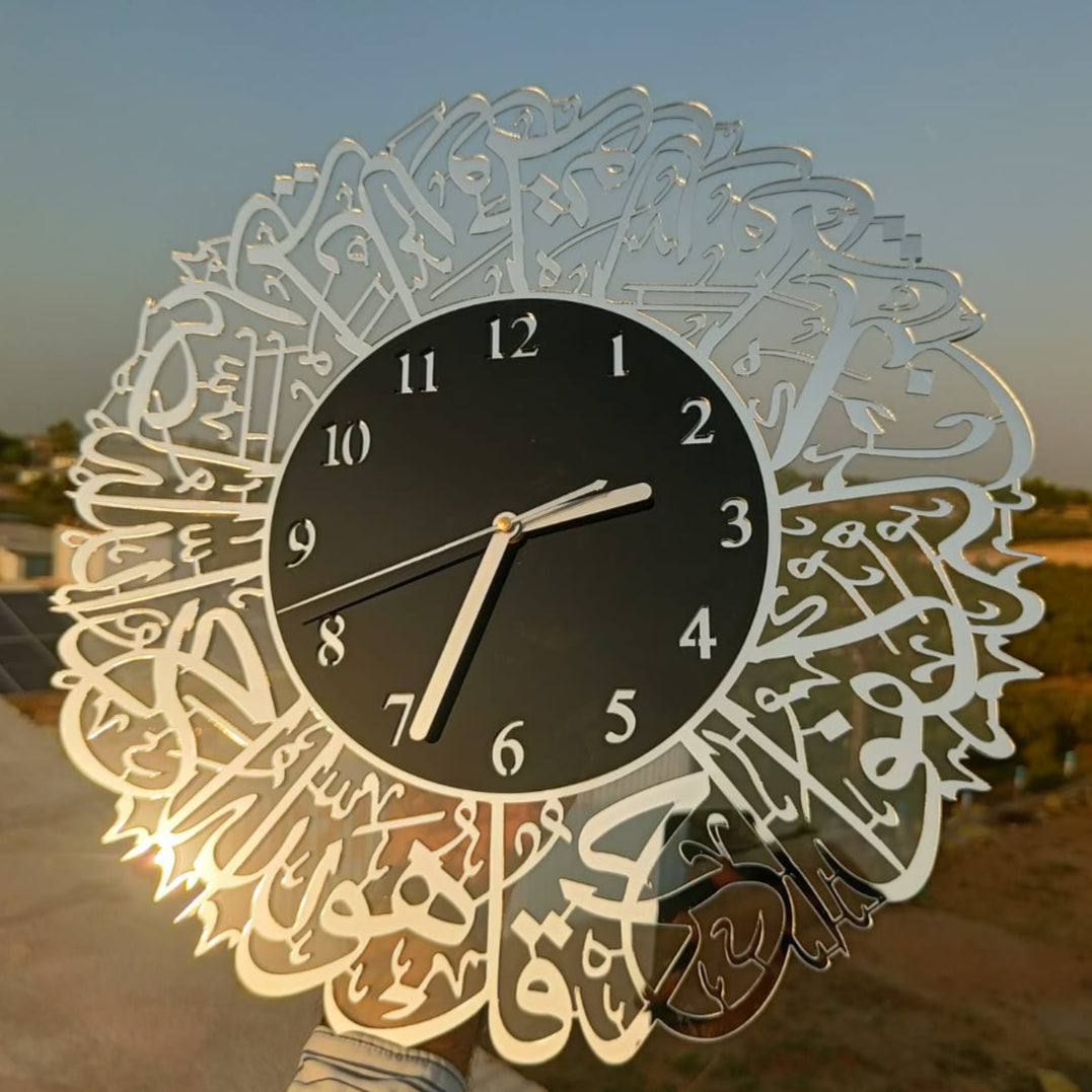 Decorative wall clock with Arabic calligraphy against a sunset background